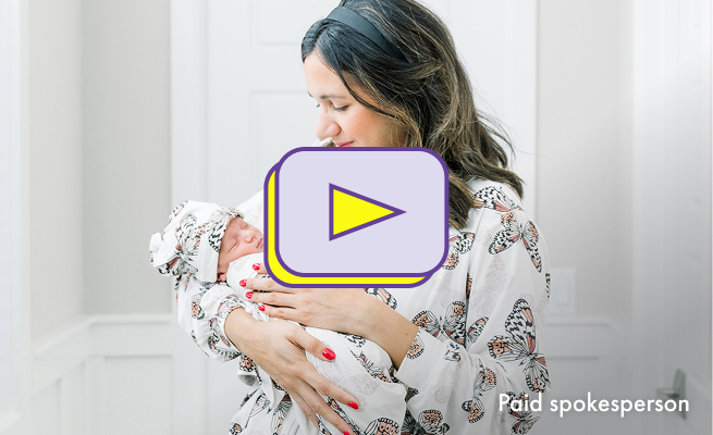 The thumbnail image for a video showing a woman holding her baby. She is smiling and looking down at the baby. A yellow and purple play button is visible.
